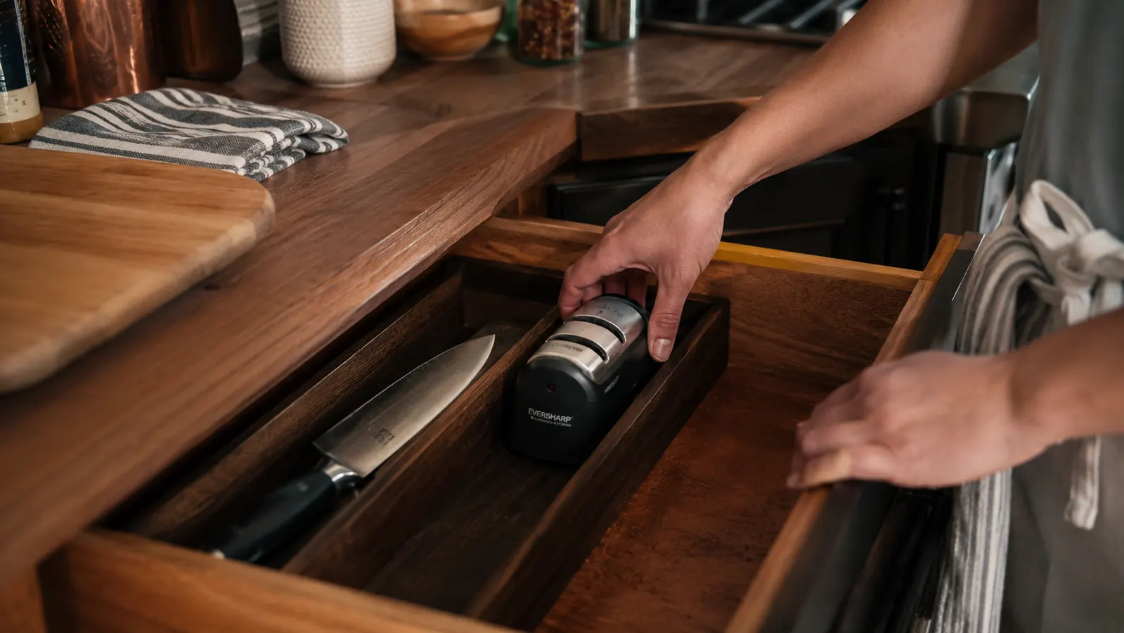 A tidy kitchen drawer with a sharpened chef's knife and the Presto sharpener stored neatly beside it
